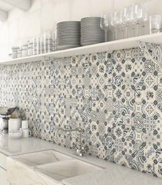 the kitchen counter is covered with dishes and cups on it's shelf above the sink