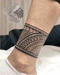 a person with a black and white tattoo on their arm is wearing a headdress