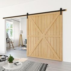 an open sliding door in a living room with white walls and wood flooring on the side