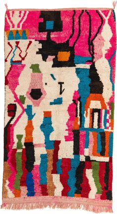 a colorful rug with fringes on the bottom and an image of a woman's face