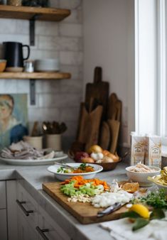 the kitchen counter is covered with many different types of food and utensils on it