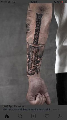 a man with a knife tattoo on his arm