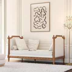 a living room with a white couch and chandelier on the wall above it