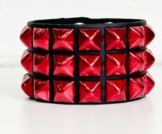 Three Row Red 1/2" Pyramid Stud  Bracelet Genuine Cowhide 7oz Weight Leather Bracelet Snap Bracelet 7oz Cowhide Leather Military Grade Rust Protected Spikes Width-1 3/4" Wide SIZE:    ALL BRACELET ARE 9"-9 1/2" LONG.  FITS 7"-9"  WRISTS Adjustable Rocker Bracelets For Party, Adjustable Rocker Bracelets For Parties, Adjustable Rocker Bracelet For Party, Adjustable Rocker Style Bracelets For Parties, Adjustable Rocker Style Party Bracelet, Handmade Punk Wristband Perfect For Gifting, Handmade Punk Wristband As Gift, Handmade Punk Wristband For Gift, Handmade Punk Wristband Ideal For Gift