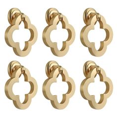 six gold metal knobs with an open design on each one side and four smaller ones in the middle