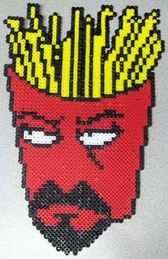 a close up of a face made out of plastic beads with fries on it's head