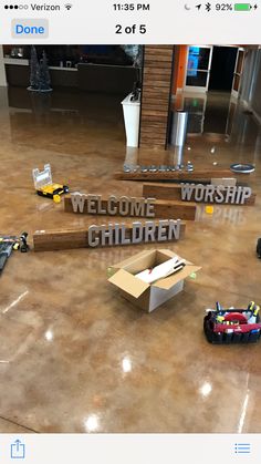 there is a sign that says welcome to worship and children with toys on the floor