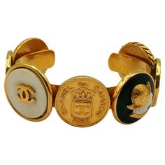 CHANEL vintage iconic gold tone bangle bracelet featuring coins : Crowned CC CHANEL 31 Rue Cambon Paris, Elephant, Helmeted Guards, CC logos and a Lady profile. Embossed CHANEL. Indicative measurements : inner measurements approx. 5.9 cm x 4.6 cm (2.32 inches x 1.81 inches) / max. width approx. 2.4 cm (0.94 inch) / wrist opening approx. 2.6 cm (1.02 inches). Material : Gold tone metal hardware / Resin. Comes with the original CHANEL box (very used vintage condition). NOTES - This is a preloved v Luxury Vintage Channel Set Jewelry, 31 Rue Cambon, Vintage Chanel Jewelry, Chanel Box, Chanel Vintage, Chanel Jewelry, A Lady, Vintage Chanel, Arm Candy