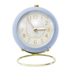 a blue alarm clock sitting on top of a metal stand