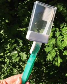 a person holding a toothbrush in their hand