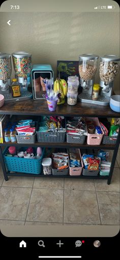 a shelf filled with lots of different items on top of a tiled floor next to a wall