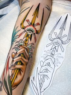 a person with a tattoo on their arm holding a pencil and an ink drawing pen