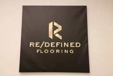 a black and gold sign that reads red / defined flooring