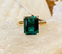 This classic 4 prong cathedral setting contains a beautiful 4.00ct. lab created emerald cut Zambian emerald. The emerald cut stone measures approximately 10x8mm. The ring is available in sterling silver, and 14k white, yellow, or rose gold. This ring makes a great promise or engagement ring. Emerald is the birthstone for May. Please send me a message if you need a size not listed. * This ring can be customized with any color center stone. All items are handmade by me in my shop in Woodbridge, NJ Solitare Engagement Rings, Emerald Solitaire Ring, Stone Ring Design, Engagement Ring Emerald Cut, Gold Emerald Ring, Emerald Cut Engagement Ring, Engagement Ring Emerald, Gemstone Rings Vintage