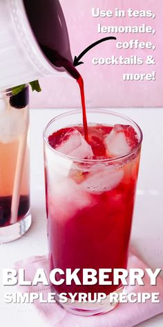 a drink being poured into a glass with ice