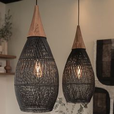 two pendant lights hanging from the ceiling in a room