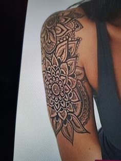 a woman's arm with an intricate tattoo design on the left side of her arm