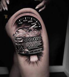 a woman's thigh with a car on it and the speedometer in front of her