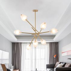 a living room filled with furniture and a chandelier hanging over the top of it