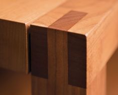 a close up view of a wooden table with two sections cut out to show the cross section