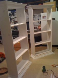 an open bookcase in the middle of a room