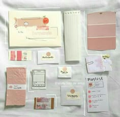 the contents of a planner spread out on a sheet of white paper with pink and orange accents