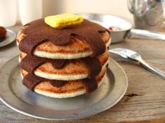 a stack of pancakes sitting on top of a metal plate