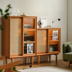 a wooden cabinet with pictures on it in a living room