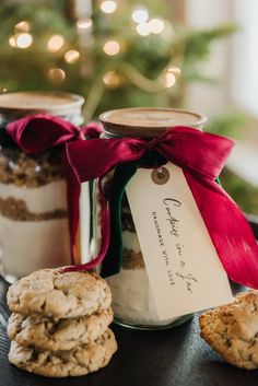 cookies in a glass jar with a red ribbon tied around it and two jars filled with cookies