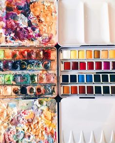 an assortment of watercolor paints in tins