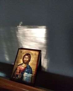 an icon is shown on a shelf in a room with sunlight coming through the window