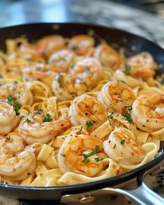 a skillet filled with shrimp and pasta