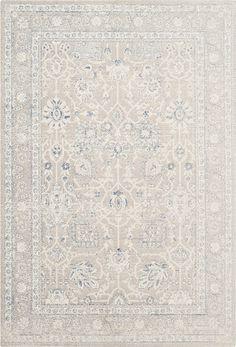 an area rug with white and blue accents on the floor, including a large medallion design