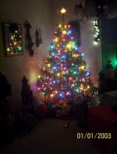 a brightly lit christmas tree in a living room