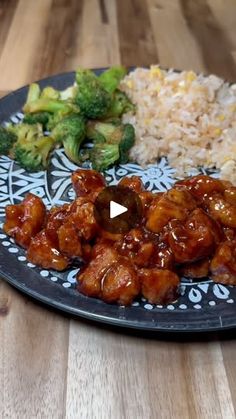 a plate full of food with broccoli, rice and meat on the side