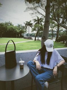 a woman sitting on top of a chair next to a table