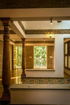 an empty room with columns and tiled floor