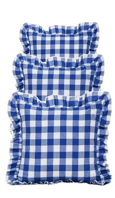 three blue and white gingham pillows with ruffles on the bottom, one in