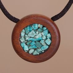 Peruvian artisans Antuane and Santos combine the beauty of recycled wood with chipped chrysocolla stone in this pendant necklace. Hanging from a black nylon cord the circle of reclaimed hualtaco wood creates a clean modern frame for a bed of blue-green chysocolla. Wood Butterfly, Geometric Pendant Necklace, Body Adornment, Rustic Materials, Elephant Lover, Eco Friendly Jewelry, Wood Necklace, Wood Pendant, Craft Accessories