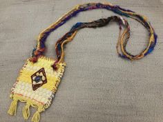 "This one of a kind bohemian necklace is made of a \"kourelou'' piece. \"Kourelou'' is the Greek name for the traditional colorful rug, made from recycled strips of cotton fabrics. The \"kourelou'' pendant is decorated with fine grosgrain fabric, which is hand embroidered with semi-precious jasper and sodalite chip beads and with high quality sari pure silk yarn in an impressive range of colors The lovely materials with different textures, the decorative hand stiches details and the vibrant summ Bohemian Handwoven Festival Jewelry, Bohemian Handwoven Jewelry For Festivals, Yellow Bohemian Long Necklace, Handwoven Bohemian Jewelry For Festivals, Traditional Rectangular Necklace For Festivals, Bohemian Multicolor Beaded Necklace With Boho Collar, Multicolor Bohemian Beaded Necklace With Boho Collar, Bohemian Multicolor Rectangular Jewelry, Yellow Long Bohemian Beaded Necklace