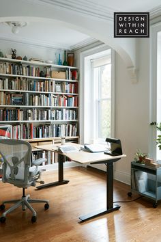 an office with a desk, chair and bookshelf full of books in it