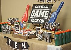 an image of a table set up for a video game party with signs and decorations