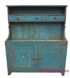 an old blue wooden cabinet with two drawers