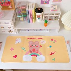 there is a teddy bear mat on the desk