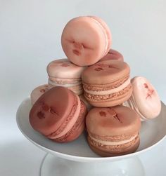 a white plate topped with macaroons on top of each other