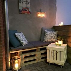 a bench made out of pallets with candles on it