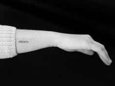 a woman's arm with the word maine tattooed on it