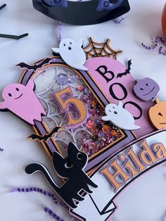 a close up of a clock on a table with halloween decorations