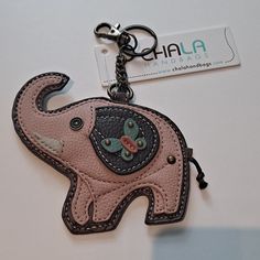 an elephant shaped keychain is shown with a tag attached to it's side