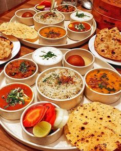 many different types of food are arranged in bowls